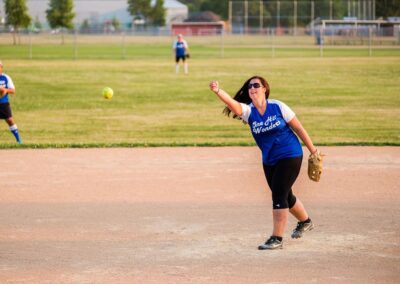 woman releasing softball during game