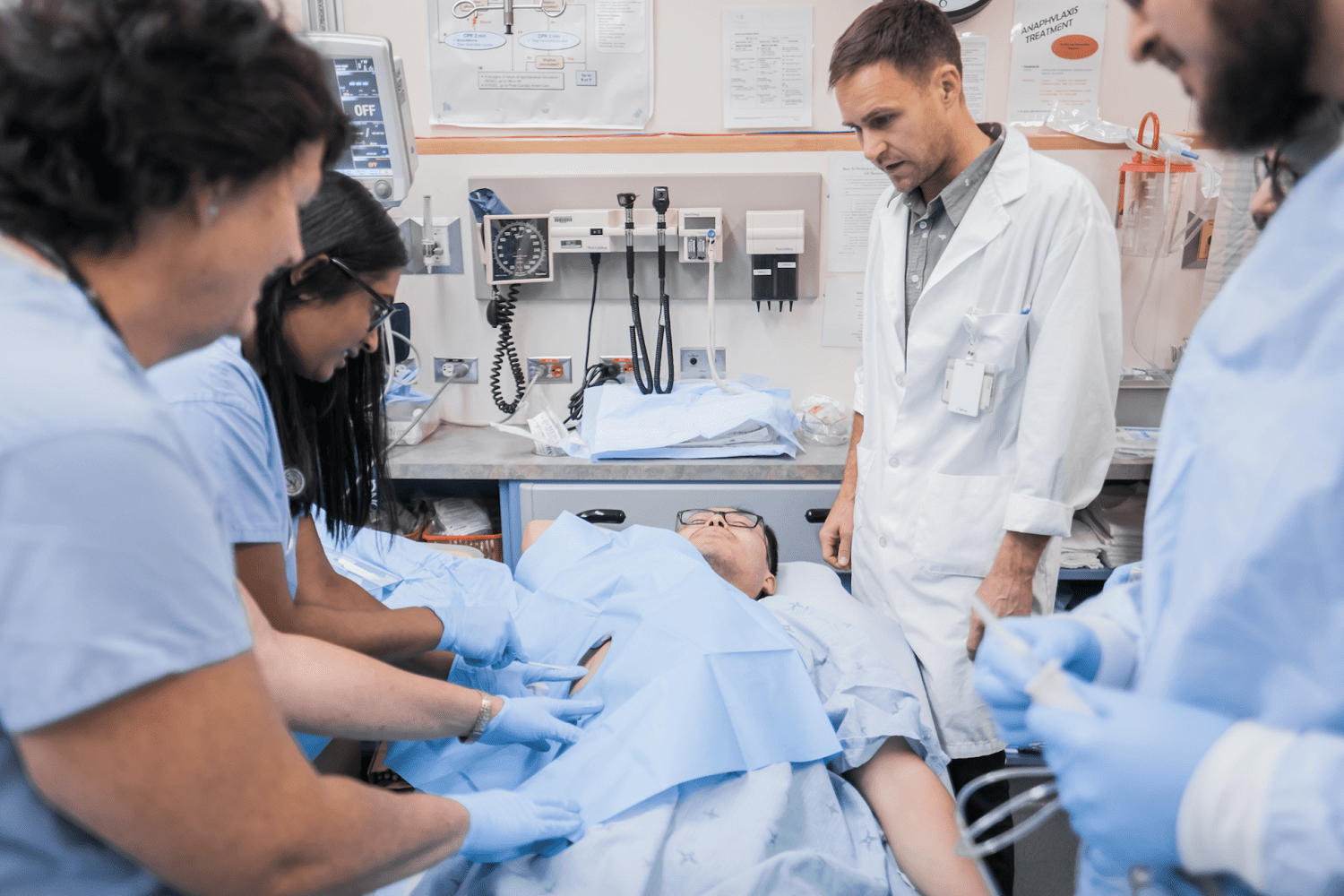 Doctors helping patient in emergency room